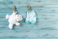 White toy bear and baby socks with stars print on a clothesline Royalty Free Stock Photo