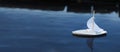 White toy boat at a pier in a pond in summer