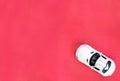 White toy car made of metal close-up on a red background. Royalty Free Stock Photo