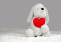 White Toy Dog With Red Valentine Heart On A Gray Background With Copy Space