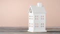 White toy model of house made of carton paper on grey table. Real estate investment. Housing cost, insurance payments. Royalty Free Stock Photo