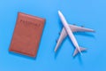 Toy plane and brown passport cover on blue Royalty Free Stock Photo