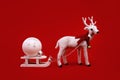 White toy reindeer on Christmas red background