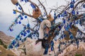 White toy Swan near the tree of desires. Evil eye in tree behind Uchisar Castle in Cappadocia, Turkey Royalty Free Stock Photo