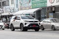 White Toyota Fortuner on the road in the city with traffic