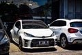 White Toyota GR Yaris GXPA16 parked on car workshop parking lot