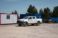 White Toyota Hilux pickup truck parked in a work area