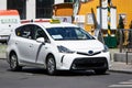 White Toyota Prius Plus hybrid taxi car waiting for a customer in Vienna, Austria