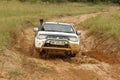 White Toyota Triton DHD crossing mud obstacle Royalty Free Stock Photo