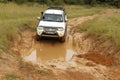 White Toyota Triton DHD crossing mud obstacle Royalty Free Stock Photo