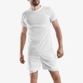 White tracksuit mockup, loose shorts with underpants compression line, t-shirt on man, isolated on background, front view