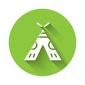 White Traditional indian teepee or wigwam icon isolated with long shadow. Indian tent. Green circle button. Vector Royalty Free Stock Photo