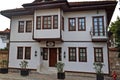 White traditional residential building with a balcony and wooden windows. Royalty Free Stock Photo