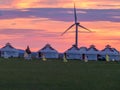 White traditional yurts located on a pasture in Xilinhot in Inner Mongolia seen during the pink sunset. Endless grassland.