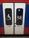 White train door with signs for bicycle and handicapped people