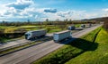 White Transportation Trucks in lines passing Royalty Free Stock Photo