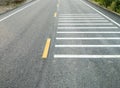 The white transverse rumble strips on the asphalt road Royalty Free Stock Photo