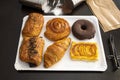 white tray with assorted pastries, chocolate and cream Neapolitan, chocolate