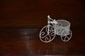 White tricycle for decoration on scintillating wooden floor Royalty Free Stock Photo