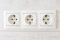 White triple electrical outlet on the wall