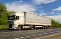 White truck on asphalt road under blue sky with clouds. Royalty Free Stock Photo