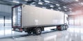 White truck with blank side trailer in brightly lit garage. Modern cargo shipping lorry waits for loading in industrial Royalty Free Stock Photo