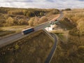 White Truck with Cargo Semi Trailer Moving on Highway Road intersection junction. Aerial Top View Royalty Free Stock Photo