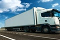 White truck and container is on highway - business, commercial, cargo transportation concept, clear and blank space on the side Royalty Free Stock Photo