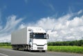 White truck on country highway under blue sky Royalty Free Stock Photo