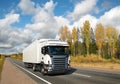 White truck on country highway under blue sky Royalty Free Stock Photo