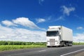 White truck on country highway under blue sky Royalty Free Stock Photo