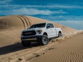 White truck driving down a sand dune Royalty Free Stock Photo