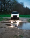 White truck in the middle of a road, headlights reflecting in the rain ponds, Kentucky, US Royalty Free Stock Photo