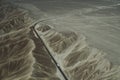 A white truck runs on the pan-American Highway through Nazca desert in Peru. Royalty Free Stock Photo