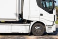 A white truck with a semi-trailer drives on the road in close-up. Motion blur Royalty Free Stock Photo