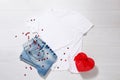White tshirt mockup. Valentines Day concept shirt, gift box heart shape on wooden background. Copy space, template blank front