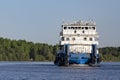 White tug pusher floats at full speed along the river Royalty Free Stock Photo