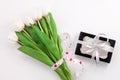 White tulip flowers and black gift box on light background flat lay. Place for text 8 March Happy Womens Mothers Day Royalty Free Stock Photo