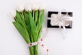 White tulip flowers and black gift box on light background flat lay. Place for text 8 March Happy Womens Mothers Day Royalty Free Stock Photo