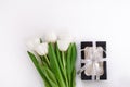 White tulip flowers and black gift box on light background flat lay. Place for text 8 March Happy Womens Mothers Day Royalty Free Stock Photo