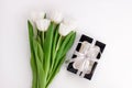 White tulip flowers and black gift box on light background flat lay. Place for text 8 March Happy Womens Mothers Day Royalty Free Stock Photo