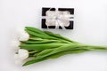 White tulip flowers and black gift box on light background flat lay. Place for text 8 March Happy Womens Mothers Day Royalty Free Stock Photo