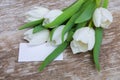 White tulips bouquet and blank greeting card Royalty Free Stock Photo