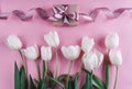 White tulips flowers and gift over light pink background. Greeting card or wedding invitation. Royalty Free Stock Photo