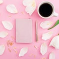 White tulips flowers with mug of coffee on pink background. Flat lay, top view. Royalty Free Stock Photo