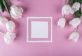 White tulips flowers and sheet of paper over light pink background. Royalty Free Stock Photo