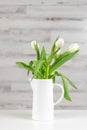 White tulips in a white pitcher