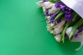 White tulips and purple irises on a green background