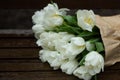 white Tulips on a wooden surface. Beautiful natural background Royalty Free Stock Photo