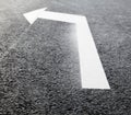 White turn left arrow on the road Royalty Free Stock Photo